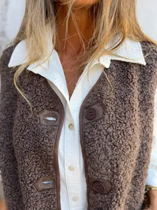 Detailed close-up view of a brown sherpa fleece vest with textured fabric and buttons