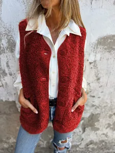 Detailed view of red sherpa fleece vest with buttons and pockets over a white shirt.