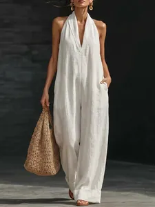 Close-up of an elegant white sleeveless jumpsuit with deep V-neck and wide leg design