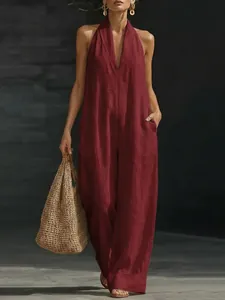 Elegant wine red sleeveless halter neck jumpsuit with deep V-neck and wide leg linen silhouette