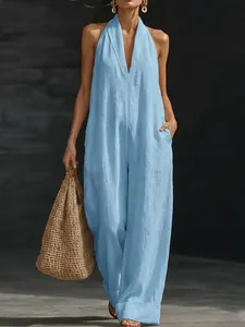 Elegant light blue halter neck sleeveless jumpsuit for women in a lifestyle setting.