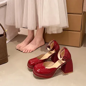 Detail view of red patent leather Mary Jane shoes with rhinestone chunky heels