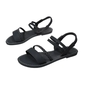 Side view detail of black Roman flat sandals with braided straps and elastic back.