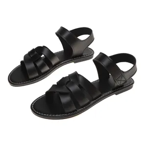 Classic women's black Roman flat beach sandals featuring an elegant cross-strap design