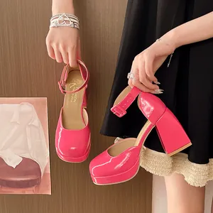 Close-up shot of hot pink patent leather platform Mary Jane shoes with thick heels.