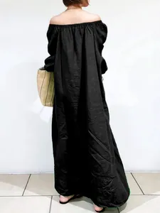 Back view of an elegant loose black off-shoulder maxi dress for casual summer style.