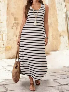 Stylish black and white striped sleeveless maxi dress for a summer beach vacation look