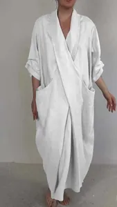 Full-length view of white linen maxi robe dress featuring a V-neck and oversized pockets