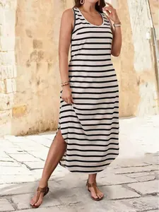Full-length view of a sleeveless black and white striped maxi dress with a stylish side slit.