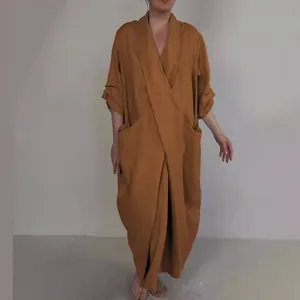 Elegant rust-colored oversized linen V-neck robe dress featuring large functional side pockets