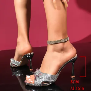Detailed side view of silver glitter high heel sandal featuring bow detail and 8cm heel.