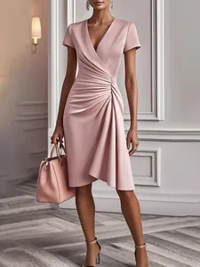 Elegant pink short sleeve dress with a V-neckline and flattering side ruching detail