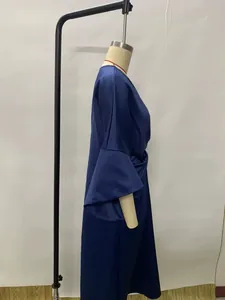 Side view detail of a navy blue satin elegant dress featuring stylish bell sleeves