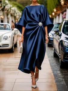 Detail of elegant navy blue satin dress with luxury crystal flower waist ornament
