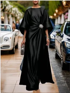 Elegant black satin maxi dress with a crystal flower brooch on the waist.