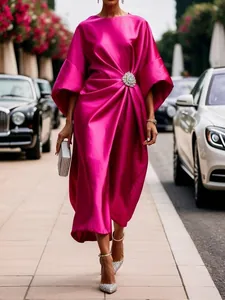 Elegant fuchsia satin midi dress with crystal flower brooch for a sophisticated look