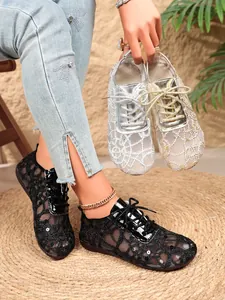 Detail view of breathable lace mesh flat shoes featuring sequin embroidery and lace-up design