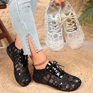 Detailed view of women's lace mesh flats with sequins and elegant lace-up design