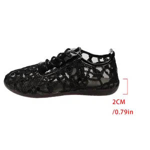 Side detail view of black lace mesh flats featuring a comfortable 2cm flat heel.
