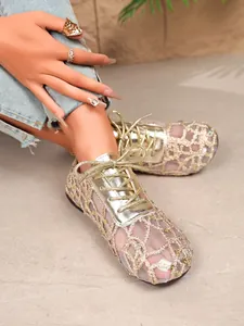 Close-up showing women's gold lace mesh flat shoes featuring an elegant hollow-out design