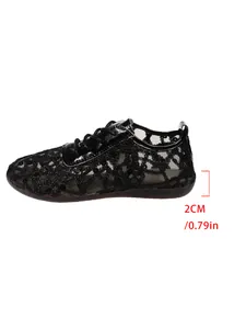 Side view of black lace mesh flats showing 2cm heel height measurement