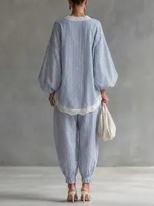 Rear view of women's blue and white striped loose set featuring elegant lace trim details.