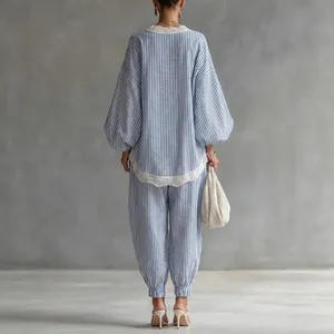 Back view of a blue and white striped two-piece set with lace trim and lantern sleeves