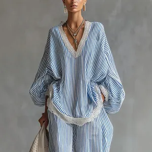 Elegant blue and white striped two-piece set with lace trim and wide-leg pants for women.