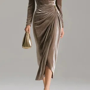 Close-up of elegant ruched velvet maxi dress with waist brooch and side slit