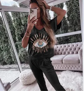 Women's summer two-piece casual outfit with a gold sequined Evil Eye pattern on the top