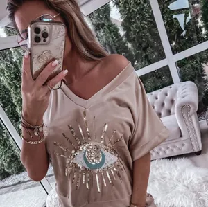 Chic beige leisure set for women with a detailed Evil Eye sequin design on the front