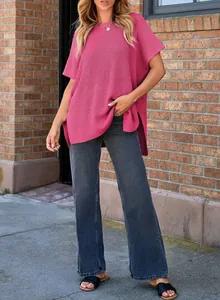 Casual pink knit top paired with grey wide-leg jeans in outdoor scene for leisure style.