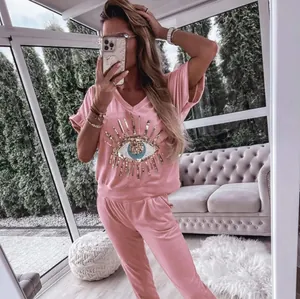 Pink loungewear set with sequined evil eye graphic top and pants
