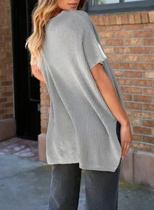Back view of a casual grey oversized knitted T-shirt showing side slits and ribbed texture