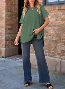 Woman wearing casual sage green ribbed knit short sleeve top paired with dark wash jeans
