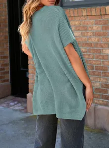Back view detail of a comfortable loose teal knit short sleeve top with drop shoulders