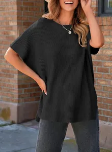 Detail of women's black ribbed knit short sleeve top with round neck and drop shoulder