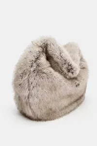 Detail of a soft faux fur winter muff or earmuffs with thick plush texture in light grey.