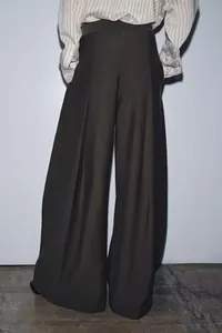 Detailed back view of high-waist wide-leg trousers with a draped fit in dark grey finish.