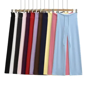 Detailed view of high-waisted wide-leg sweatpants in multiple colors on a rack