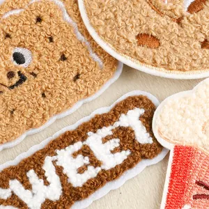 Macro view of cartoon food chenille towel embroidery iron-on patches for DIY clothing.
