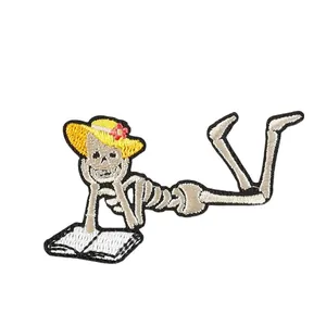 Funny cartoon skeleton wearing sun hat reading book embroidered patch for DIY clothes