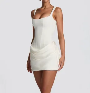 Close-up detail of white sleeveless bodycon dress with corset waist and draped skirt