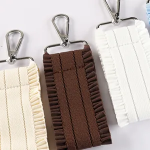 Ruffled fabric keychain straps in cream, brown and white with durable silver lobster clasps
