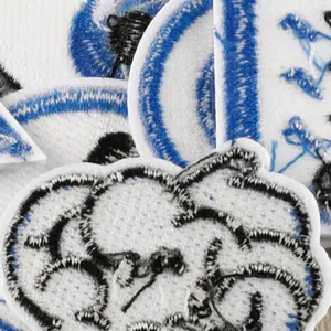 Detailed view of blue and black embroidered iron-on patches for DIY clothing decoration