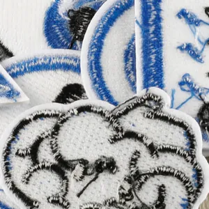 Macro close-up detail of blue and white embroidered patches for DIY garment decoration