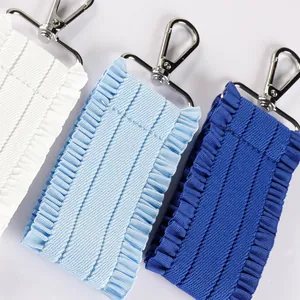 Handmade pleated ruffled ribbon keychain strap for bags and luggage in various blue tones.
