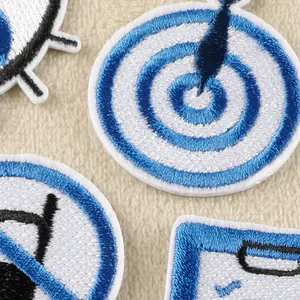 Close-up view of intricate blue and white embroidered iron-on patches with target design