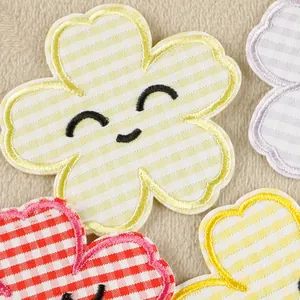 Set of colorful striped and gingham flower patches with smile embroidery