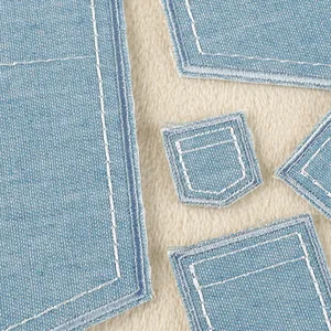 Light blue denim faux pocket patches with white stitching for clothing repair and DIY